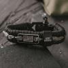 image:imageHero Company Never Forgotten Paracord Bracelet  Tactical Survival Bracelet for Men with Bronze USA Flag  Helps Pair Military Veterans with a Companion DogBlackGrey